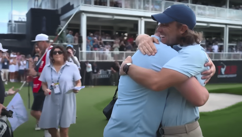 Fleetwood shares a moment with his stepson off the 18th green at Eastlake.
