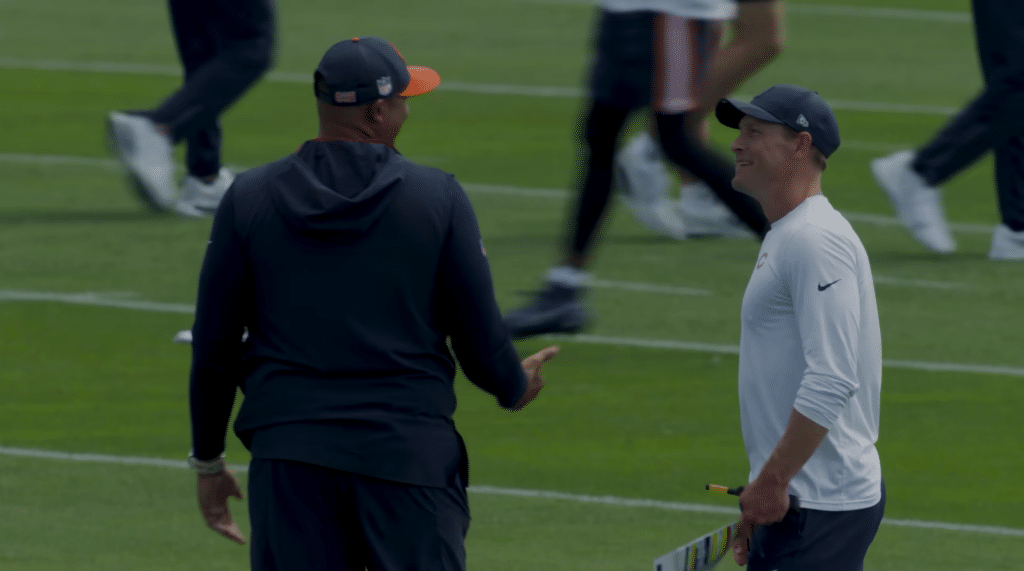 New Bears head coach Ben Johnson talks strategy with GM Ryan Poles during practice.
