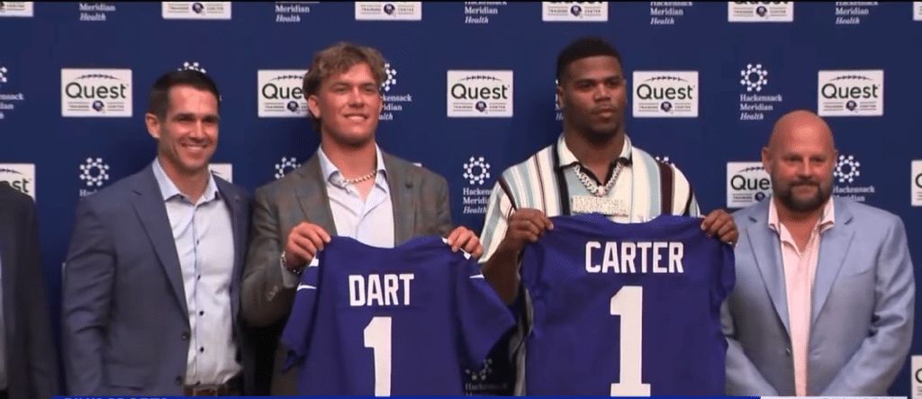 New Giants rookies Jackson Dart and Abdul Carter pose with their team jerseys.