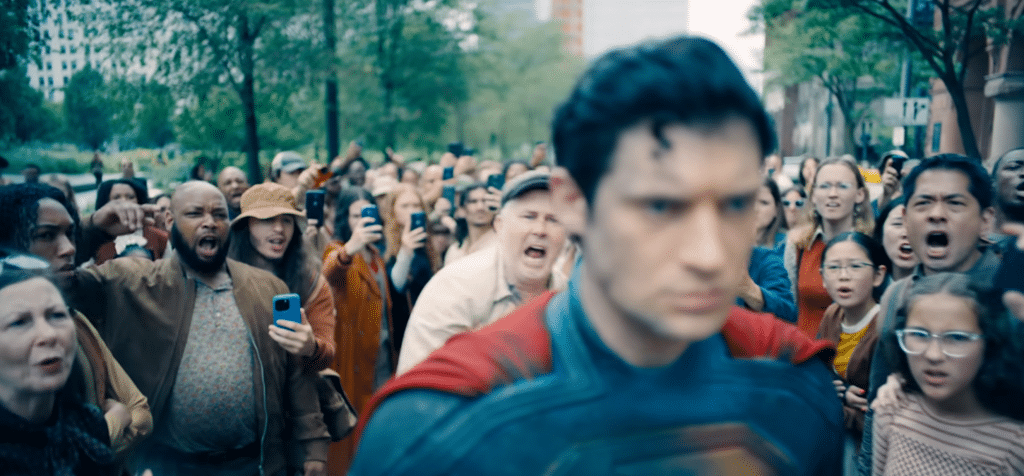 Superman walking away from an angry crowd.