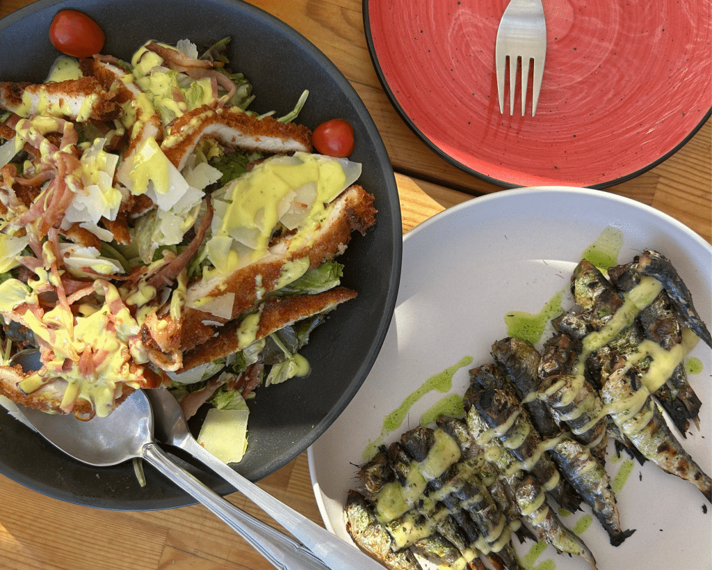 Photo of a fresh chicken salad and grilled fish
