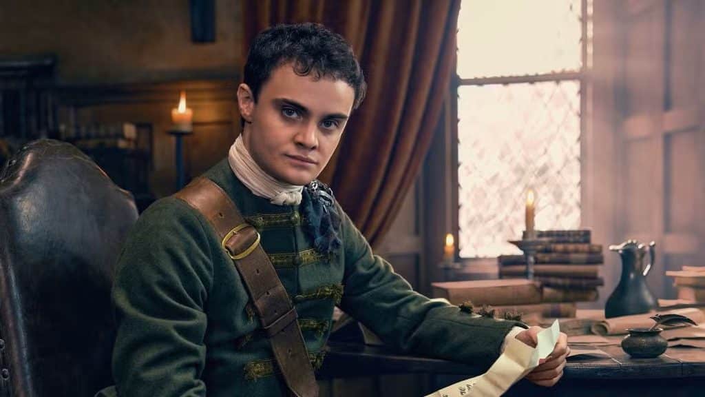 Seamus McLean Ross as Colum Mackenzie reading a note at a desk as Colum MacKenzie.