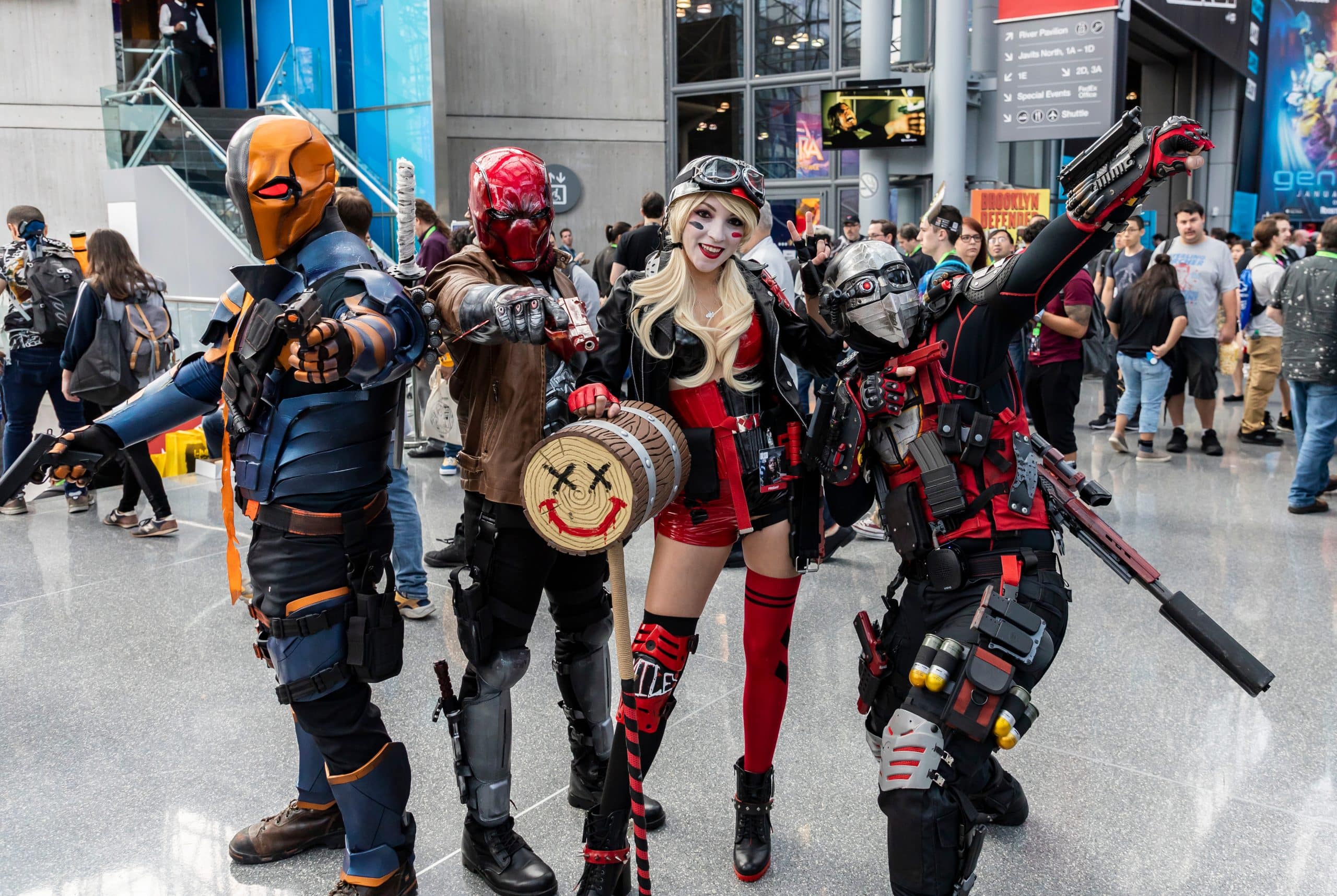 Cosplayers at 2018 New York Comic Con dressed as DC characters Deathstroke, Red Hood, Harley Quinn and Deadshot (from left to right).
