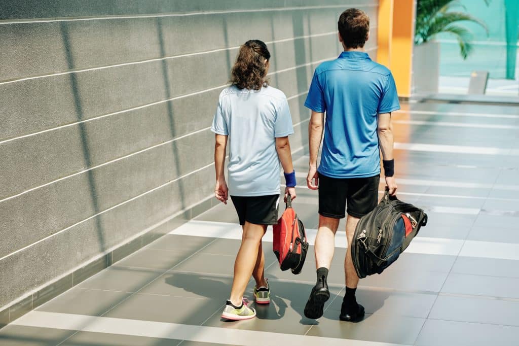 Two people with sports bags