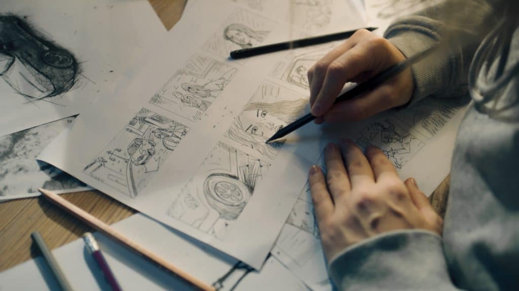 Artist draws comic book character designs