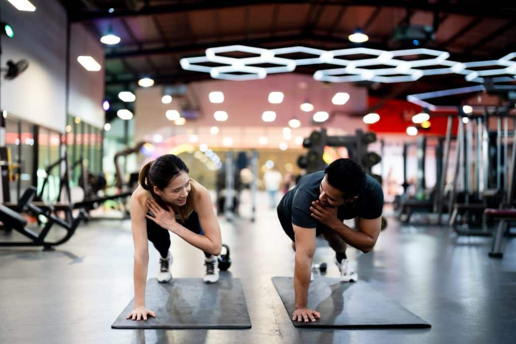 Two people working out in a gym