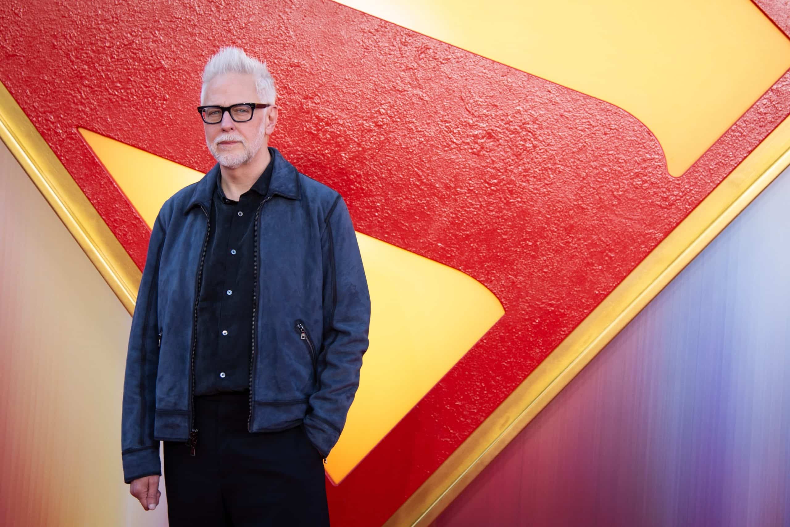 James Gunn posing before a Superman shield at his movie's London premiere.