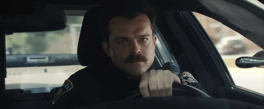 Police officer driving a police car in the movie, Weapons.