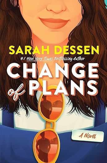 Cover of Dessen's new book. A close-up cartoon teenage girl with brown hair and sunglasses hanging off her shirt. In the reflection of the glasses, we can see a teenage boy, presumably her love interest.
