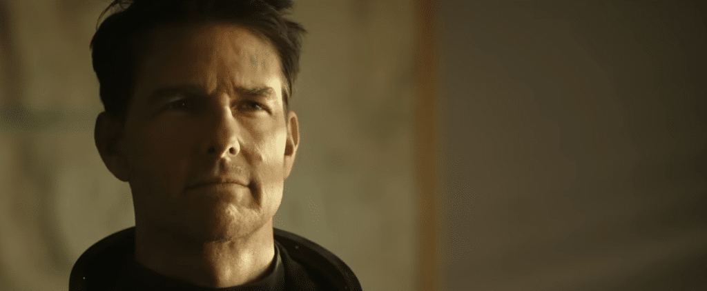 Tom Cruise looks intensely at something off camera.