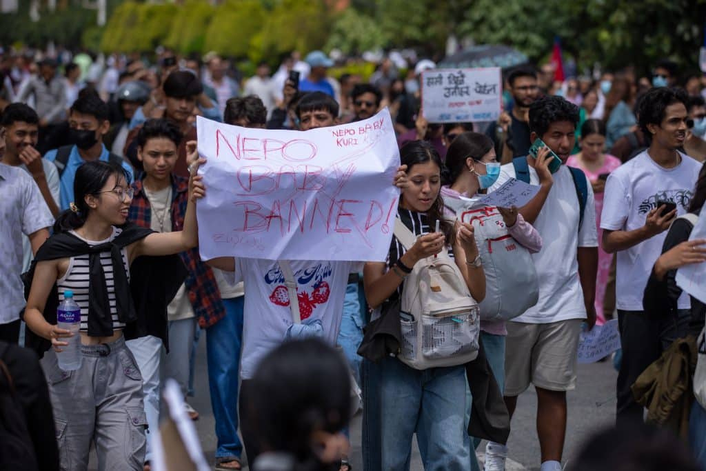 Youth in Nepal marching in Kathmandu, Nepal, holding signs saying "Nepo Baby Banned"