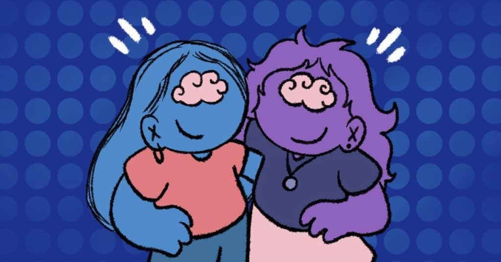 Two people hugging each other and smiling