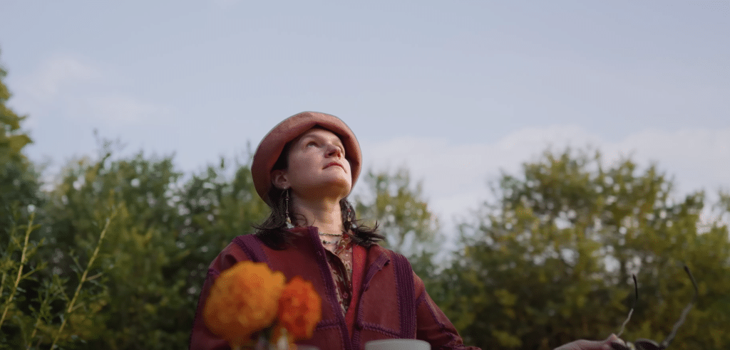 Adrianne Lenker looking up to the sky