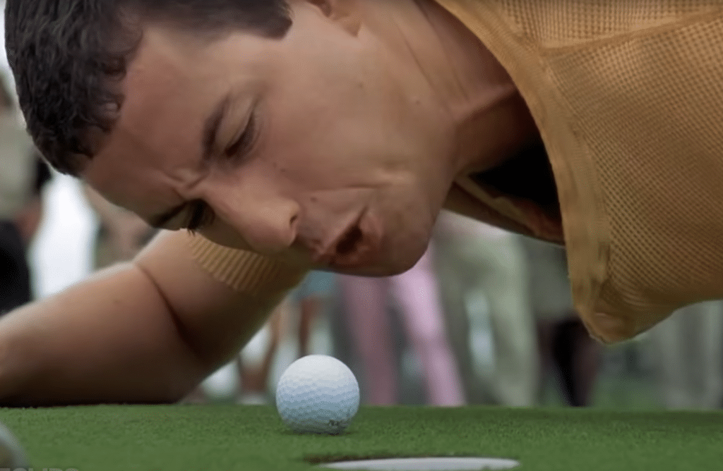 Happy taking his rage out on his failed putt.