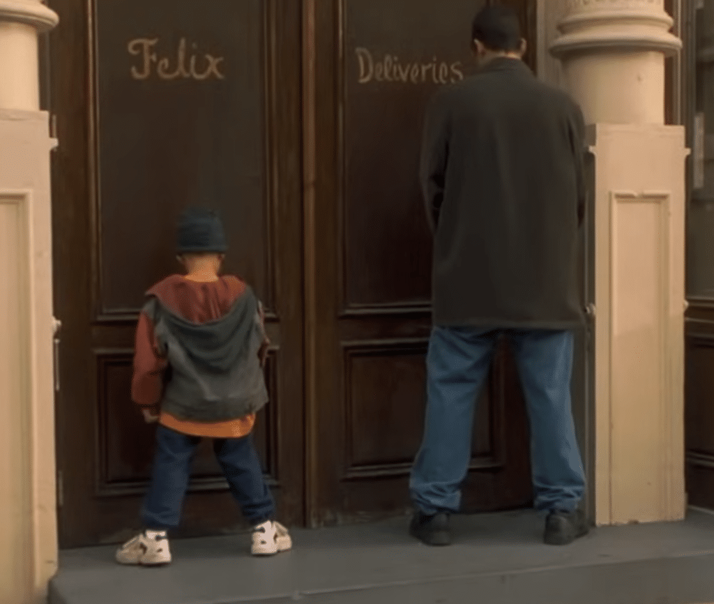 Sonny teaching Julian to urinate on a building.