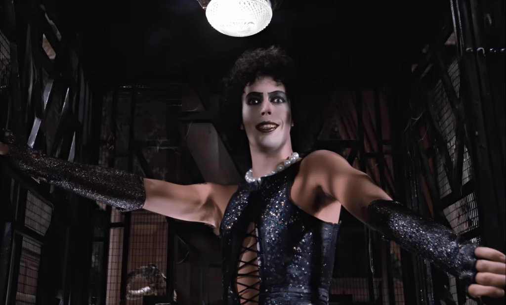 Frank-N-Furter (Tim Curry) in elevator.