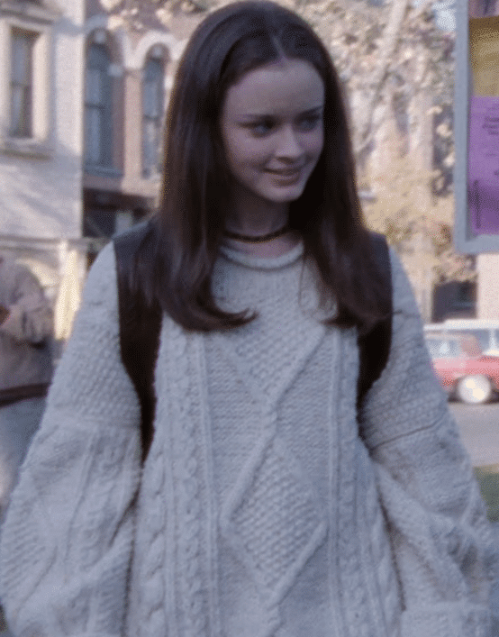 Rory in a large white sweater.