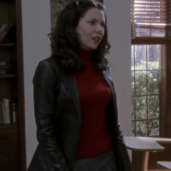 Lorelai in a leather jacket and red top.