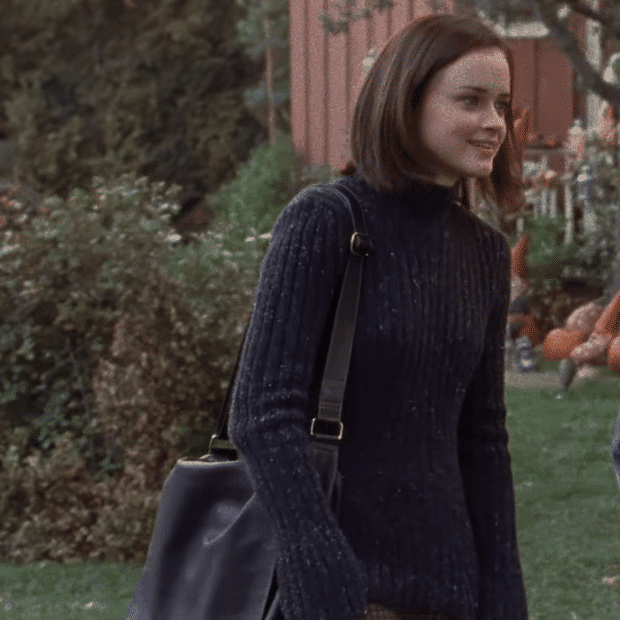 Rory in a sweater and skirt.