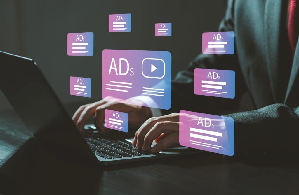 A person accesses the internet from their computer, but is inundated with ads.