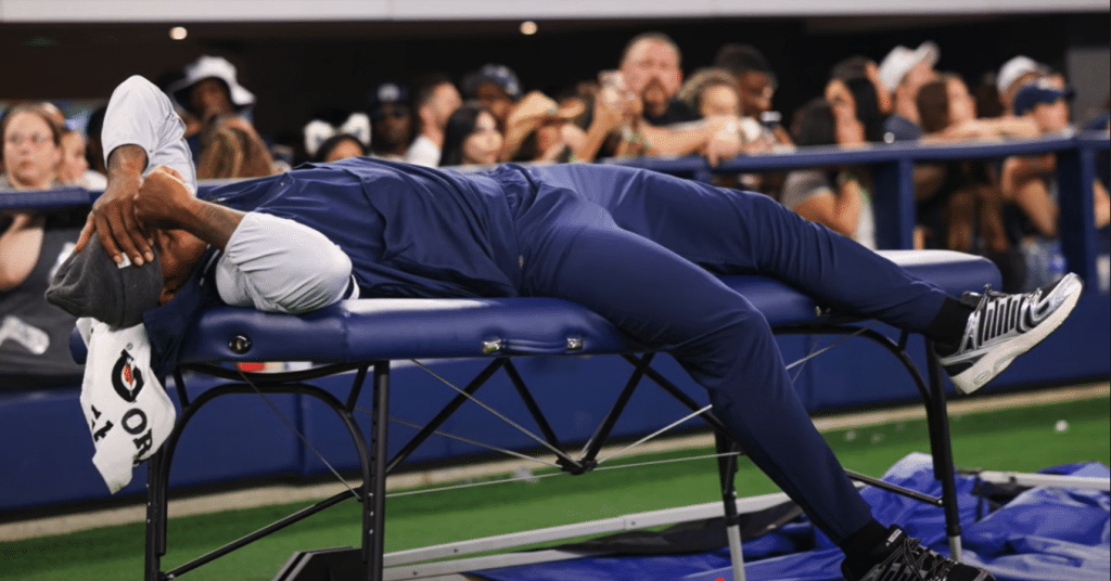 Micah Parsons lays on a trainer's table during the Cowboy's preseason game against the Atlanta Falcons (BehindThePlay / YouTube)