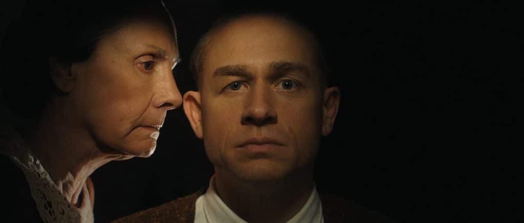 A promotional photo of Ed Gein with Augusta Gein as played by Charlie Hunnam and Laurie Metcalf respectively.