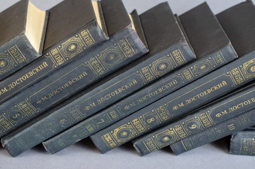A collection of Dostoevsky books, in Russian, stacked diagonally.