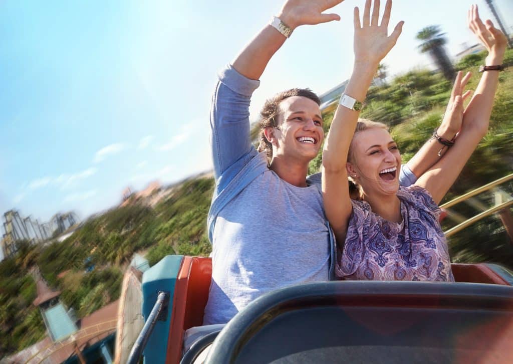 Couple riding an exciting rollercoaster