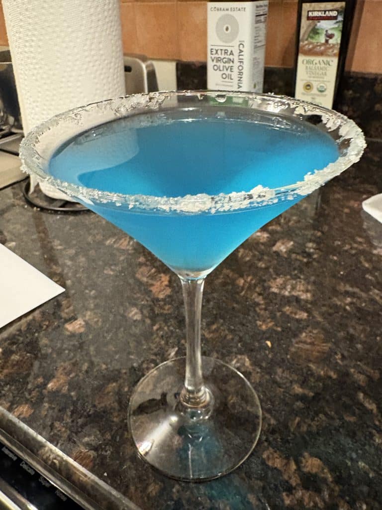 Poison Apple Martini Halloween Drink sitting on a counter