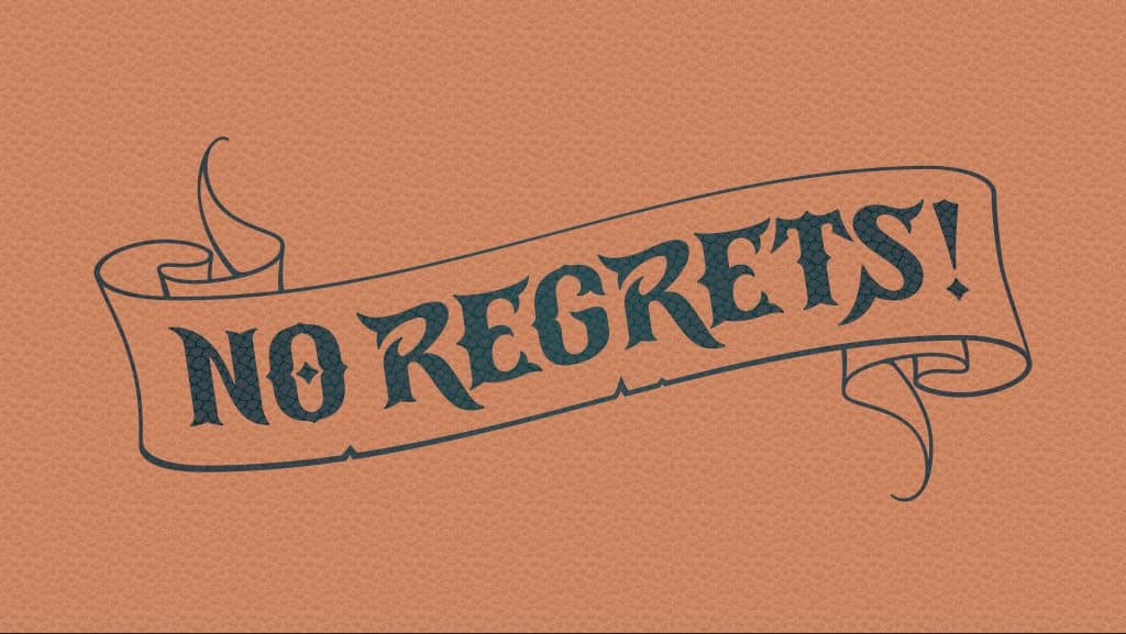 Image of 'No Regrets' scrolled out in a tattoo script across a leather background.