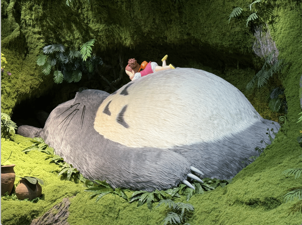 A sculpture of Studio Ghibli's Totoro lying down.