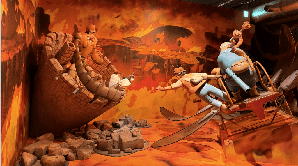 Action scene from Ghibli's "Laputa: Castle in the Sky" with the protagonists surrounded by a sea of fire.