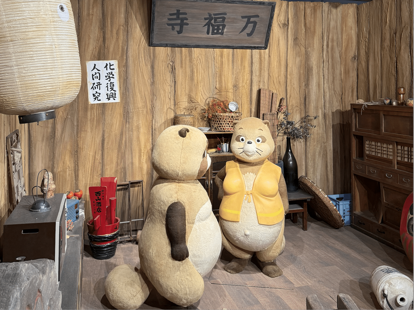 A cozy interior from "Pom Poko" with two sculptures of the characters.