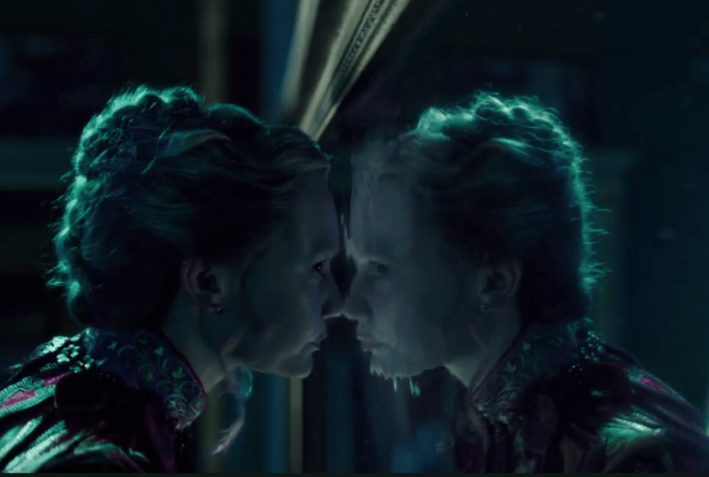 Alice walking through the mirror. Credit: YouTube/Disney UK