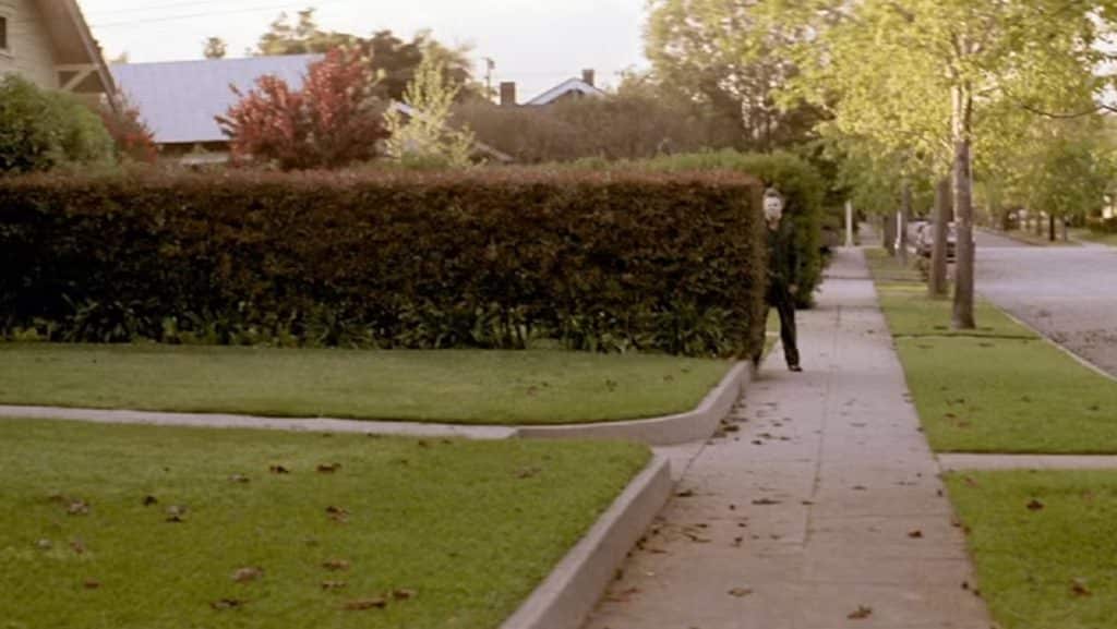 Michael myers peers around bush in halloween