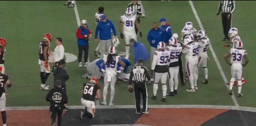 Damar Hamlin receiving medical attention after collapsing on the field.