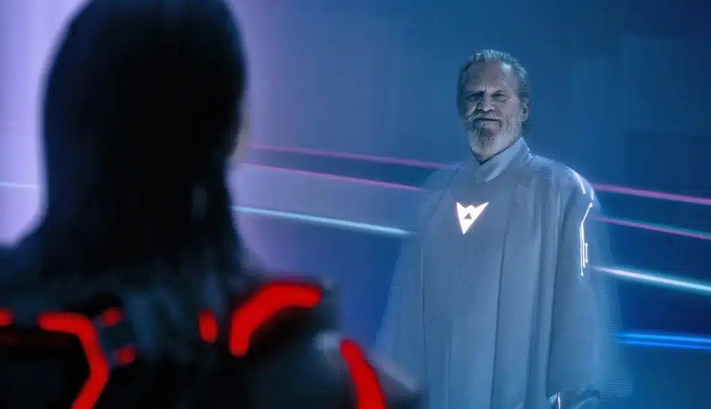 A man in a white robe smiles at Ares, whose back is to the camera.