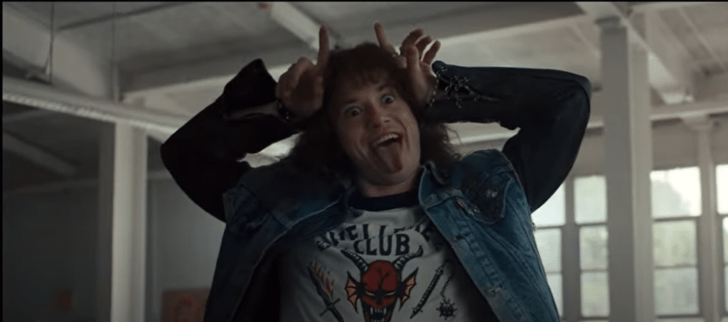 Eddie Munson from Stranger Things with his tongue out, making devil horns at Jason Carver after his emotionally heated speech about his hatred for basketball. This reveals a common ADHD symptom: emotional dysregulation.
