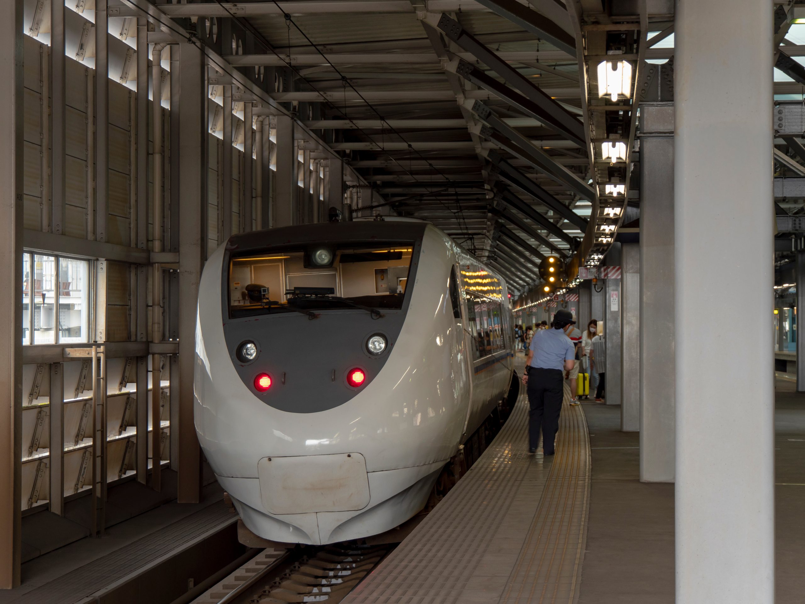 A train attendant stood beside the train.
