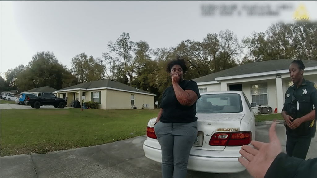 Ajike “AJ” Owens (left) with police officers called by Susan Lorincz. (Image: Netflix)