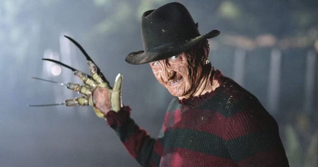 freddy krueger from nightmare on elm street staring menacingly while raising his razor-bladed glove