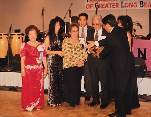 Moling and Sesiang Rufo accept an award at a meeting of the Pangasinan Association of Greater Long Beach (1990s).