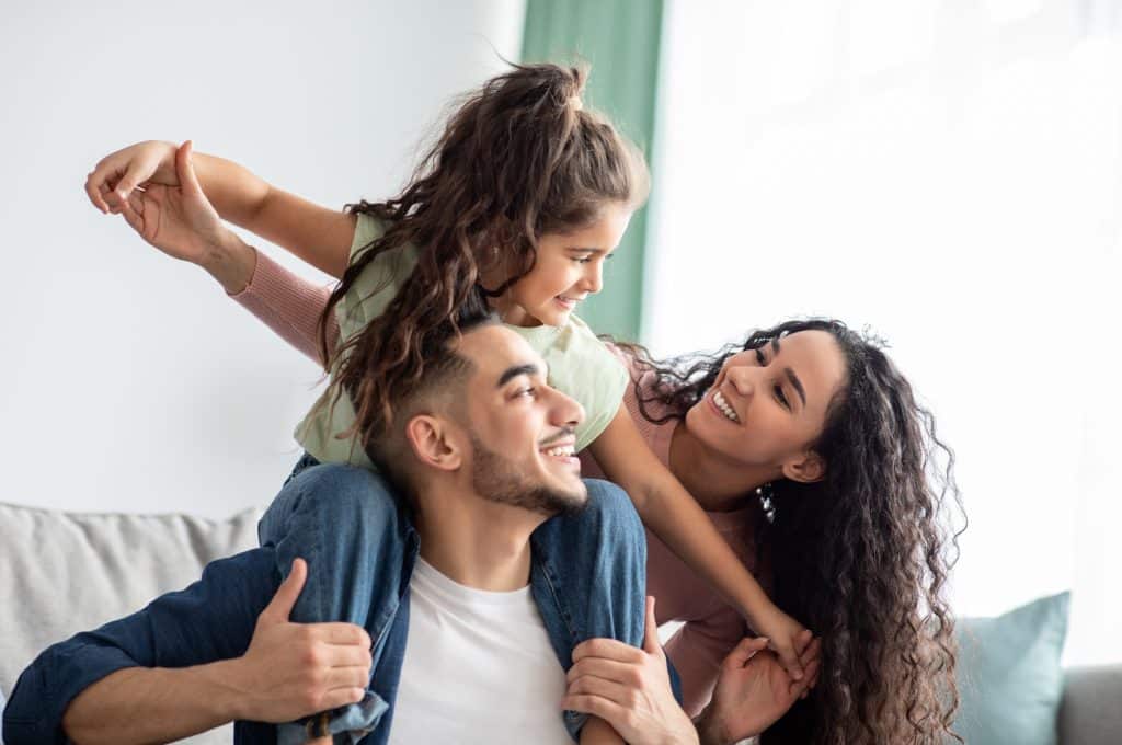 A mother and a father with their daughter.