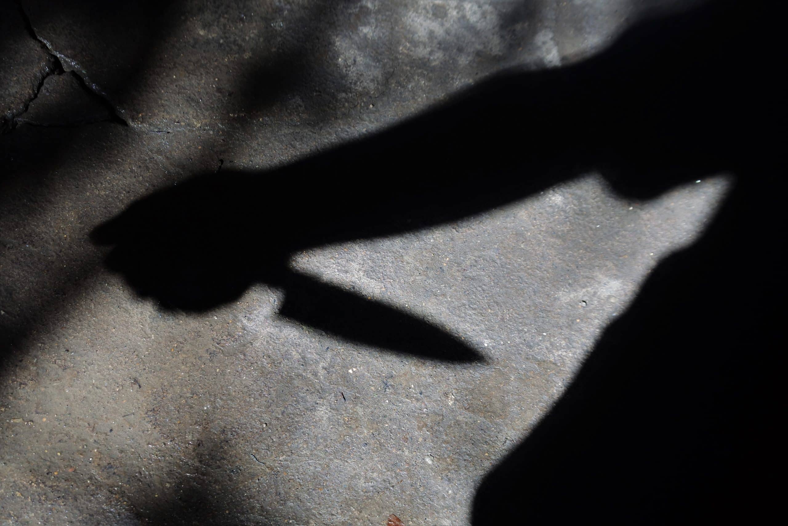 Silhouette of sad male holding knife. concept of killing