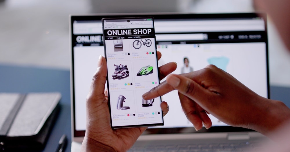 A close up of someone scrolling on an Online Shop on their phone. It is selling bikes and helmets.