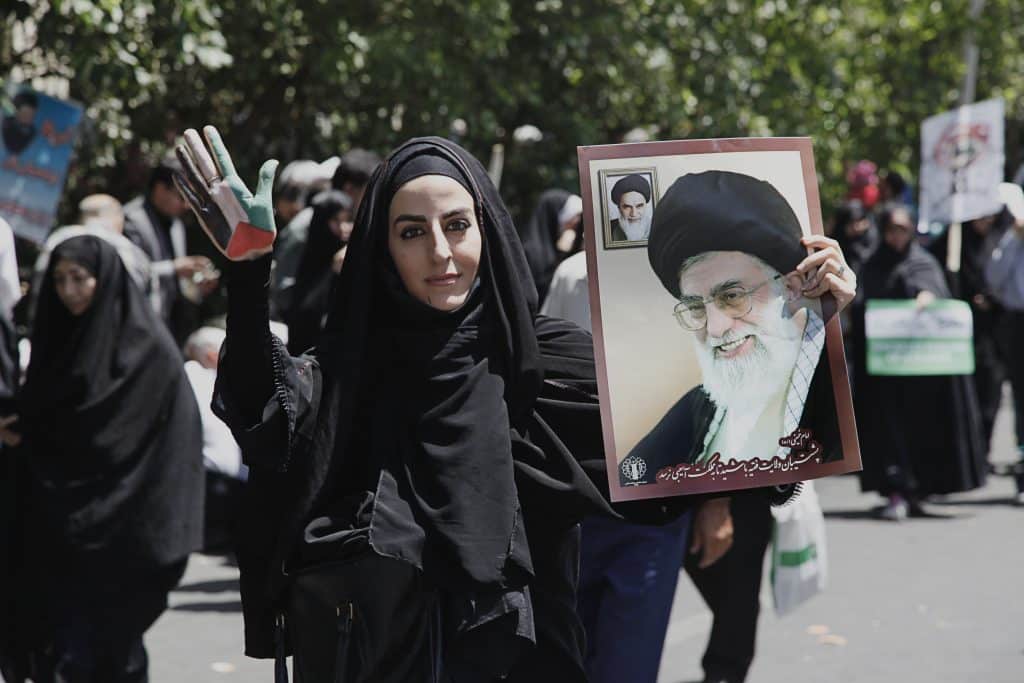 A woman with a placard of Ali Khamenei on Qods Day protests, Tehran.