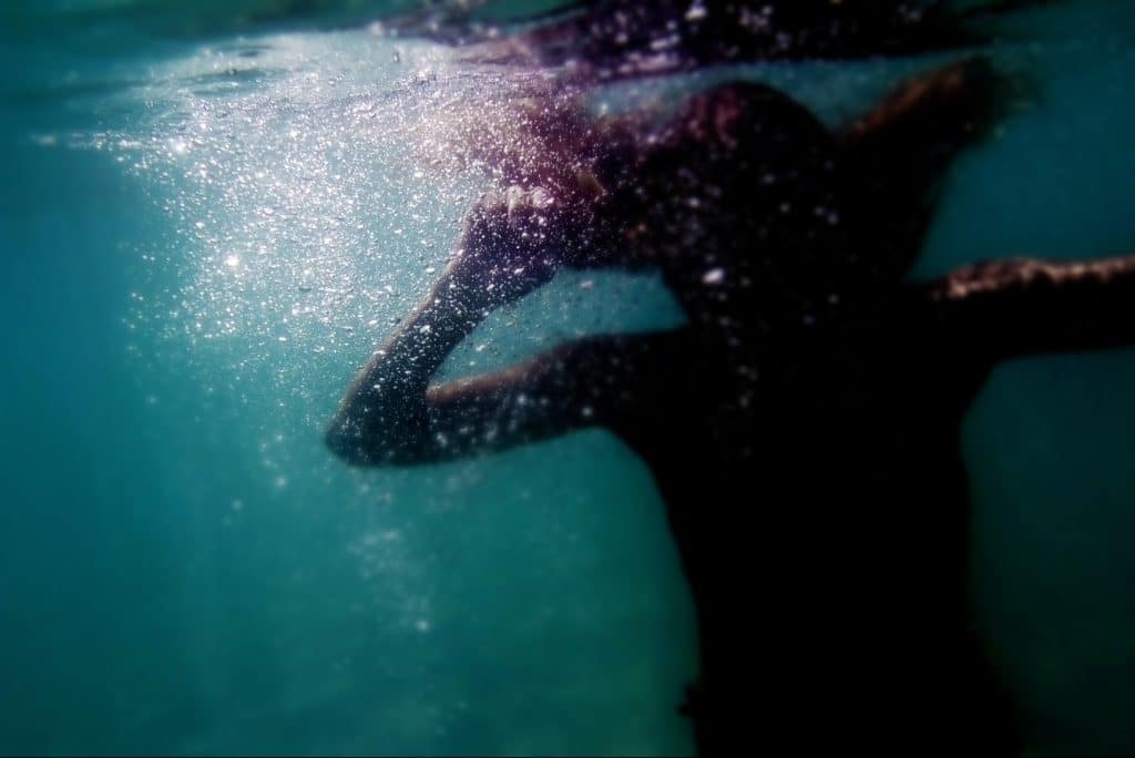 Female figure underwater.