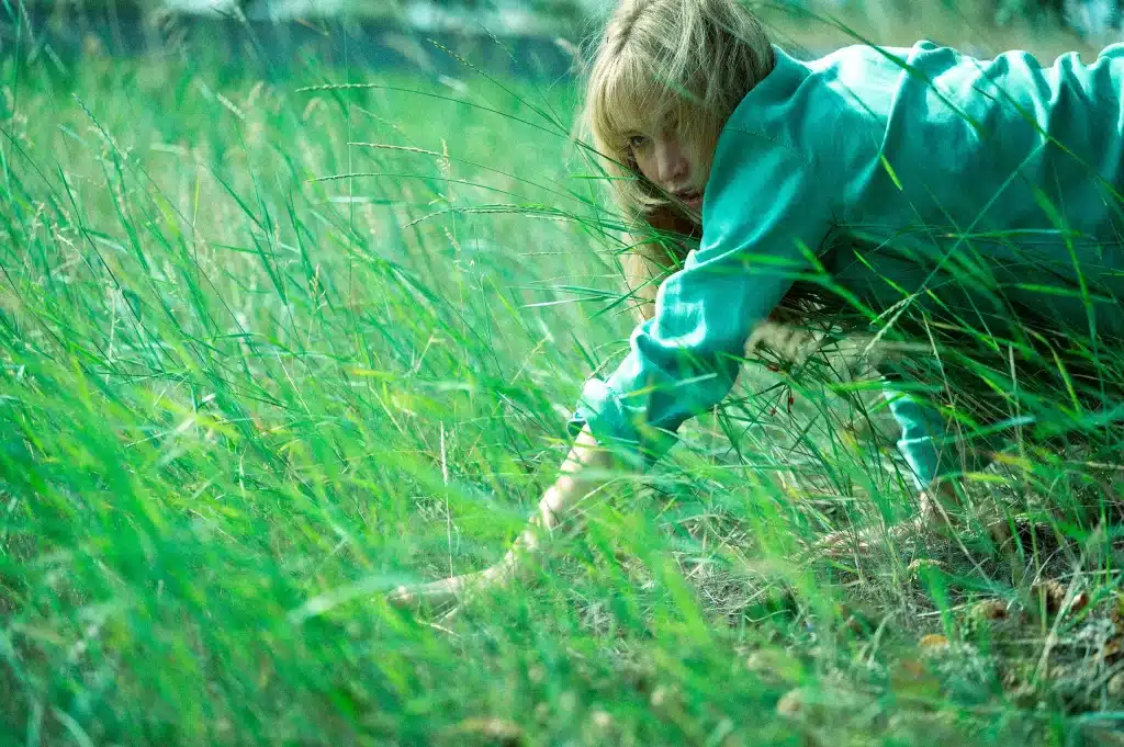 Jennifer Lawrence crawls around in the grass