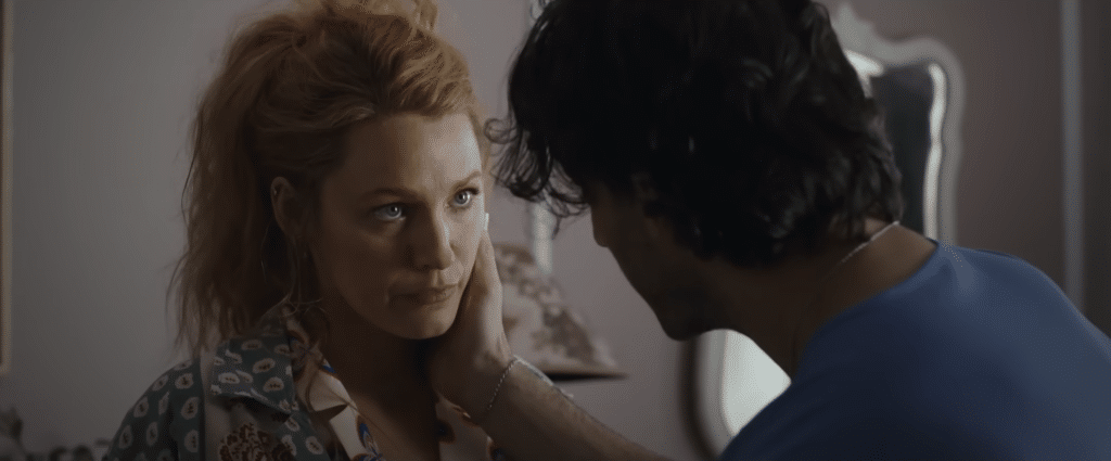 Black Lively Looking at Justin baldoni with his hand on her cheek in the movie It Ends with Us