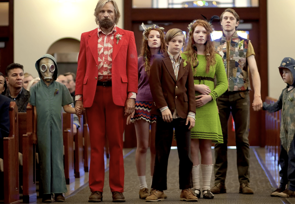 A family in eccentric clothing stands in a church aisle.